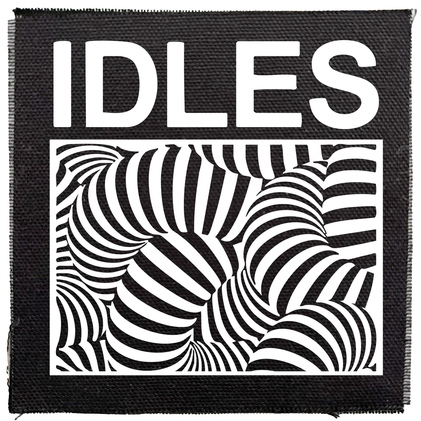 Black patch with 'IDLES' text and black and white abstract design on a white background